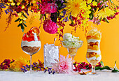 Cocktail Desserts and flowers on yellow background
