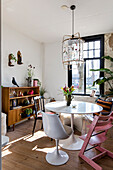 Dining room with vintage sideboard, white tulip table and various chairs