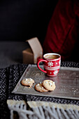 Popcorn cookies and red cup of coffee with snowflakes ornament