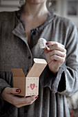 Woman holding Advent gift box with snowball cookies