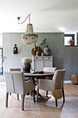 Dining table with chairs and rustic decoration in grey and brown tones