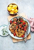 Pork chops with grilled aubergine and tomato ragout