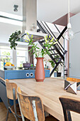 Kitchen with blue cooking island and dining table with chairs