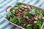 Still life close up healthy, fresh salad with walnuts and croutons\n