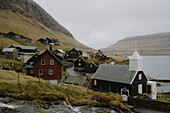 Church and houses in idyllic, remote fishing village, Bour, Vagar, Faroe Islands\n