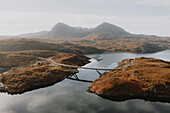 Scenic view bridge over water in mountain landscape, Assynt, Sutherland, Scotland\n