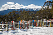 Ski fence in sunny, idyllic winter mountains\n