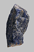 Close up blue Bolivian sodalite stone on gray background\n