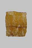 Close up textured yellow Chinese fluorite stone on gray background\n
