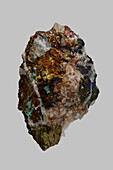 Close up detail textured multicolored German chalcopyrite stone on gray background\n