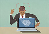 Businessman at laptop pulling at string in brain\n