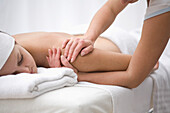 Woman receiving a back and shoulder massage\n