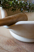 Close up of mortar and pestle with rosemary\n