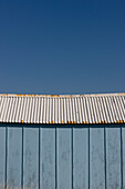 Close up of light blue beach hut and blue sky\n
