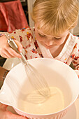 Young girl baking in kitchen\n