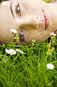 Young woman laying on a field of flowers\n