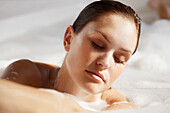 Young woman in a bubble bath\n