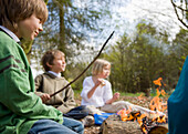 Children sitting around a campfire\n