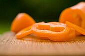 Sliced orange peppers on a chopping board\n