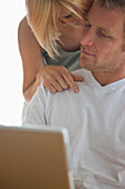 Young couple in front of laptop computer\n
