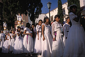 Young girls in white dresses during religious procession, Semana Santa, San Miguel de Allende, Mexico\n