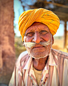 Head and shoulders portrait of desert flute player, Jaisalmer, Rajasthan, India\n