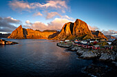 Sonnenaufgang über den majestätischen Bergen, die das Dorf Hamnoy umgeben, Lofoten Inseln, Nordland, Norwegen, Skandinavien, Europa