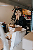 Female worker checking equipment inventory\n