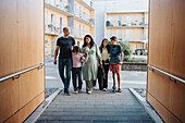 Family standing in courtyard of residential neighborhood\n