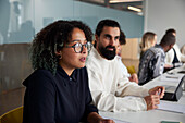 Woman sitting during business meeting and looking away\n