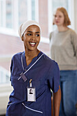 Smiling female doctor in hospital looking away\n