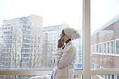 Female doctor looking away and talking via cell phone\n