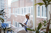 Female doctor standing and using digital tablet\n