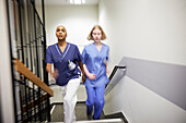 Female doctors walking at staircase together\n