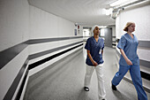 Female doctors walking through hospital corridor\n
