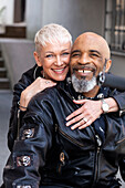 Portrait of cool mature biker couple in leather clothes\n