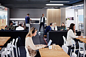 Woman working solitary in office cafeteria\n