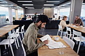Man working solitary in office cafeteria\n