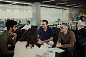 Group of business people having meeting in lobby\n