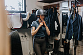 Woman putting riding cap to get ready for horseback riding\n