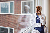 Young female doctor talking on phone at work\n