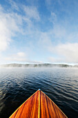 Boat on Lake Placid in morning mist\n