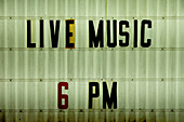 Live music signage outside honky tonk\n