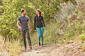 Mid adult couple hiking in forest\n