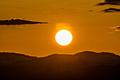 Setting sun seen above mountains near Sun Valley\n