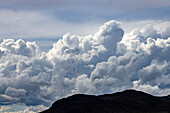 Majestic cumulus clouds above mountains\n