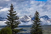 USA, Idaho, Stanley, Fog over forest by Sawtooth Mountains\n