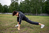 Young woman stretching legs before workout\n