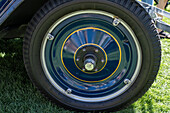 Detail of the pinstriped wheel on a restored vintage 1927 Chevrolet Series AA Capitol sedan in a car show in Moab, Utah.\n
