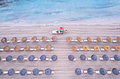 Aerial view of rows of beach umbrellas with a lifeguard tower on an sandy beach, Sicily island, Italy, Mediterranean Sea, Europe\n